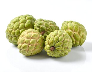 Obraz premium Several ripe, green, textured fruit are presented on a white surface