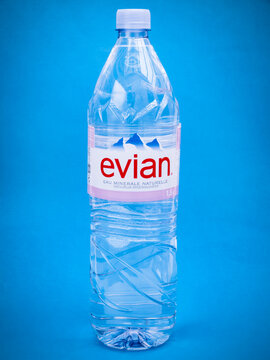 Evian plastic bottle on blue background
