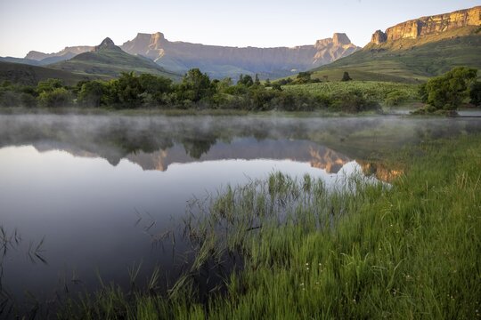 Sunrise, amphitheatre with reflection in the lake, Royal Natal National Park, Drakensberg Mountains south, Kwa Zulu Natal, South Africa