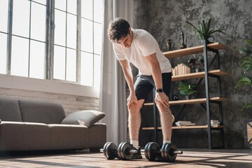 Home, fitness man rest with weights for workout, strength development muscle training for health...