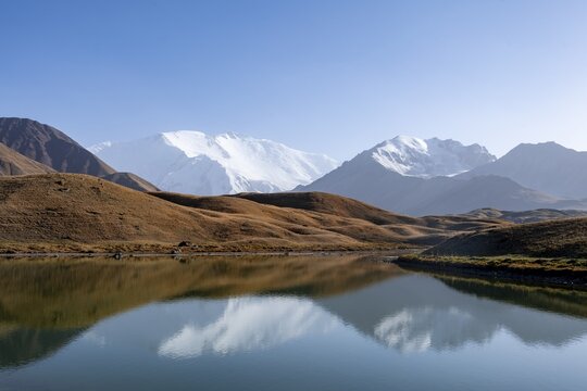 Mountains reflected in a small mountain lake, Pik Lenin, Trans Alay Mountains, Pamir Mountains, Osh Province, Kyrgyzstan