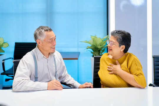 Two senior business people friendly talking together in meeting room of office for introduce yourself to working.