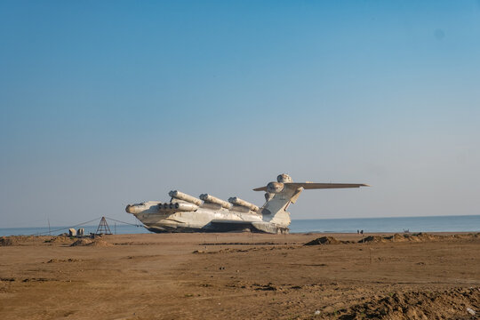 Lun Ekranoplan Lies on the Sand at a Former Military Testing Site in a Coastal Area During Clear Weather