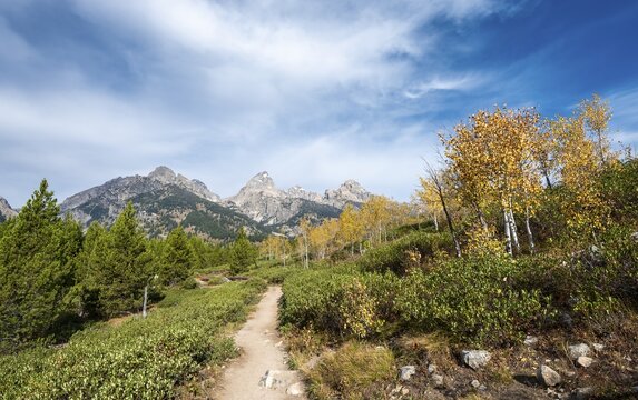 Hiking trail to Taggart Lake in autumn, view of the Teton Range, Grand Teton National Park, Wyoming, USA
