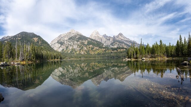 Reflection in Taggart Lake, view of the Teton Range, peaks Grand Teton and Teewinot Mountain, Grand Teton National Park, Wyoming, USA