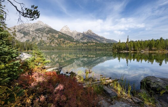 Reflection in Taggart Lake, view of the Teton Range, peaks Grand Teton and Teewinot Mountain, autumn, Grand Teton National Park, Wyoming, USA