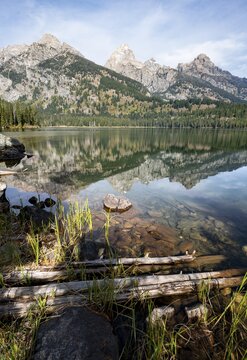 Reflection in Taggart Lake, view of the Teton Range, peaks Grand Teton and Teewinot Mountain, Grand Teton National Park, Wyoming, USA