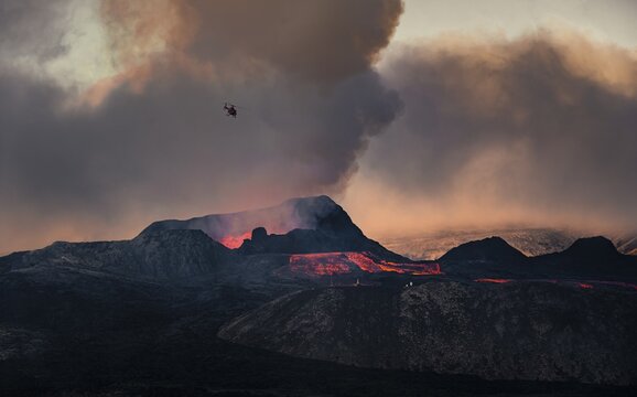 Helicopter flying over nus erupting volcano with lava fountains and lava field, crater with erupting lava and lava flow, Fagradalsfjall, Kr&yacute;suv&iacute;k volcano system, Reykjanes Peninsula, Iceland