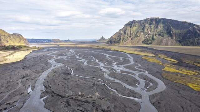 River with fanned out branches through black lava sand, Sk&aacute;larfjall and Remundargilsh&ouml;fud mountains, Icelandic highlands, aerial view, M&uacute;lakv&iacute;sl river, &THORN;akgil, Iceland