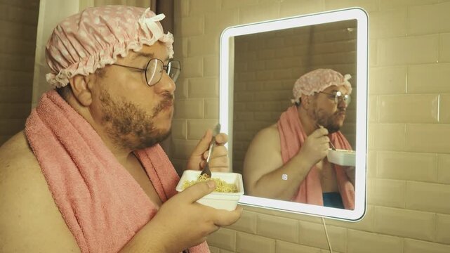 A funny fat man overeats tasty and unhealthy food. Happy guy 