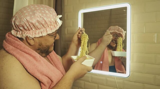 A funny fat man overeats tasty and unhealthy food. Happy guy 