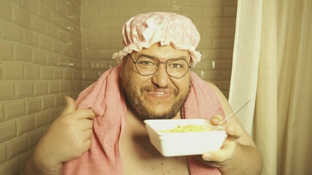 A funny fat man overeats tasty and unhealthy food. Happy guy 