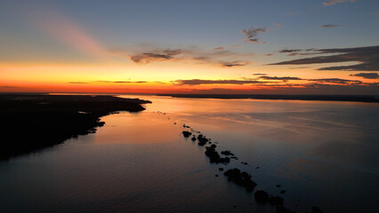 Fototapeta premium Colorful Sunset In Manaus Amazonas Brazil. Capturing The Effects Of Flooding In The Amazon Rainforest. Sunset Savage Nature Forests Shore. Forest. Manaus Amazonas.