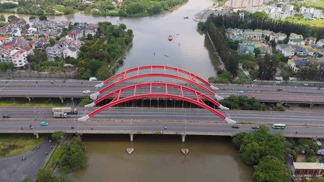 Aerial view of Ong Lon Bridge on Nguyen Van Linh Boulevard with urban traffic and canal, modern infrastructure scene in Ho Chi Minh City