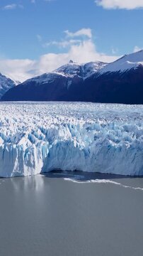 Los Glaciares National Park At El Calafate Santa Cruz Argentina. Glacier Calving Into Icy Lagoon With Snow Capped Mountains. Outdoor Travel Destination Patagonia Glacier.