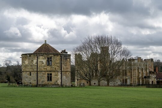 the conduit house the round tower or water tower of cowdray house Midhurst West Sussex England with the ruins in the background