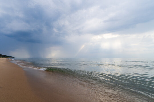 Storm clouds on horizon over Lake Michigan beach in summer