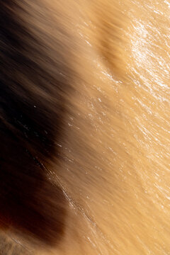 Abstract Lake Michigan wave flowing across sand creating natural shoreline pattern