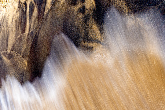 Abstract motion blur wave washing over sand on Lake Michigan beach