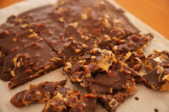 Close up photo of a healthy snickers snack made with chocolate, peanut butter and dates from a wider angle