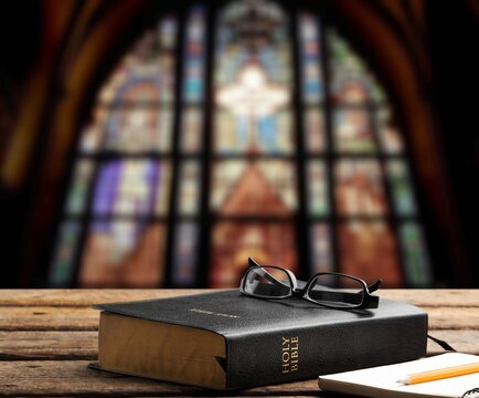 Christian wood cross and open bible book, Holy concept