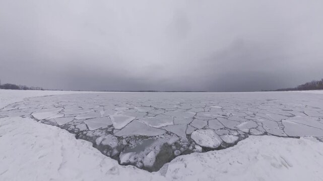 Frozen Lake Ontario Ice Sheets at Cherry Beach Toronto During Winter, Cracked Ice Patterns Across Frozen Water Under Dramatic Overcast Sky