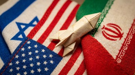 Fototapeta premium Origami rocket on flags of Israel USA and Iran symbolizing geopolitical tensions and potential conflict.