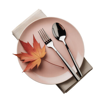 Autumn table setting with pink plate, silverware, and maple leaf isolated on a transparent background