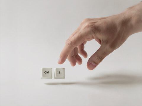 Hand Reaching For Floating Ctrl And Z Keyboard Keys For Undo Concept