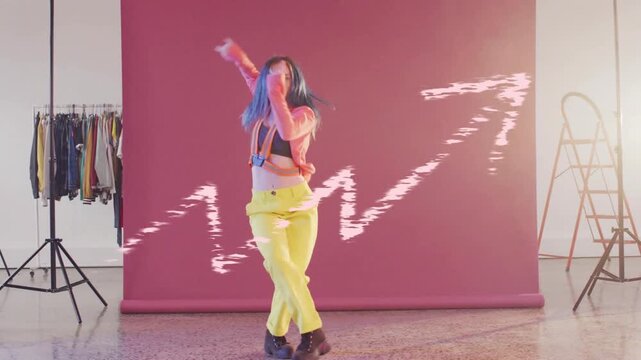 NB dancer opening arms dancing, modeling fashion on pink set glitch across frame obscuring subject