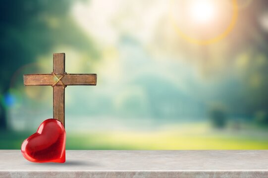 Red heart and Christian wooden cross