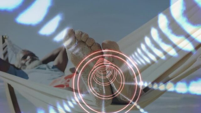 Closeup starting, man reclining hammock showing sandy feet, rings pulsing and highlighting soles