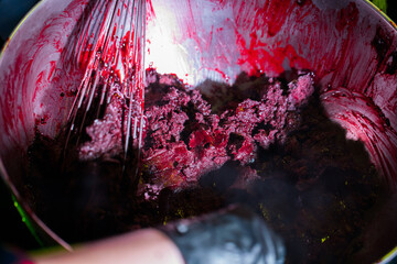 Close-up of a vibrant red berry mixture being whisked in a metal bowl. The glossy texture and rich color create an appetizing culinary scene. Perfect for food blogs, baking tutorials, or recipe promot © Video_for_you