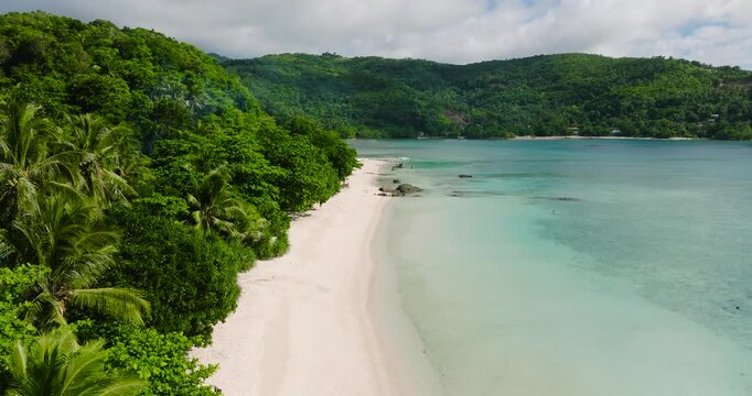 Ocean waves in white sand coastline in Tiamban Beach with turquoise water. Romblon, Philippines.