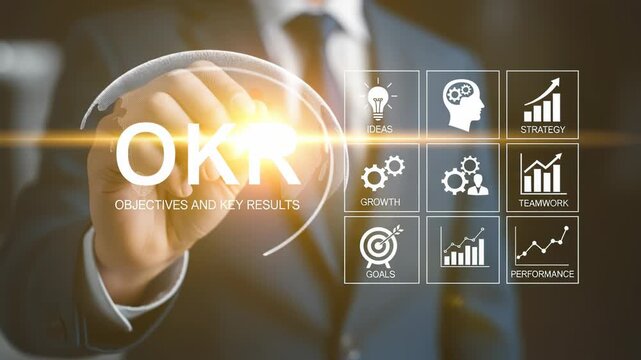 Businessman touches OKR text with glowing light, strategy icons surround