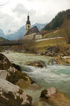 famous view in Ramsau over the Ramsauer Ache river to the parish church of St. Sebastian