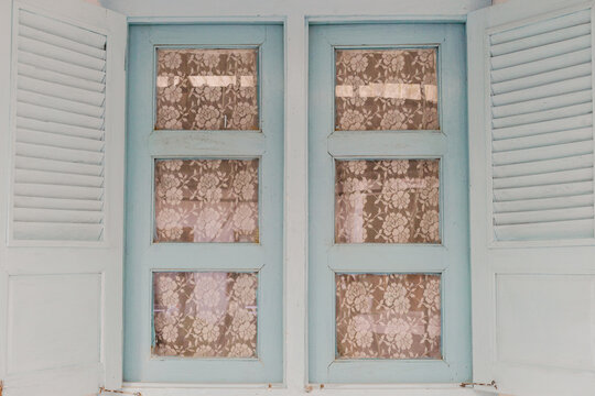Vintage doors with floral window panes.