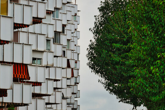 A striking vertical composition capturing a detailed geometric pattern of a modern white apartment building, in M&oacute;stoles, Spain. Ideal for concepts of housing crisis and high prices.