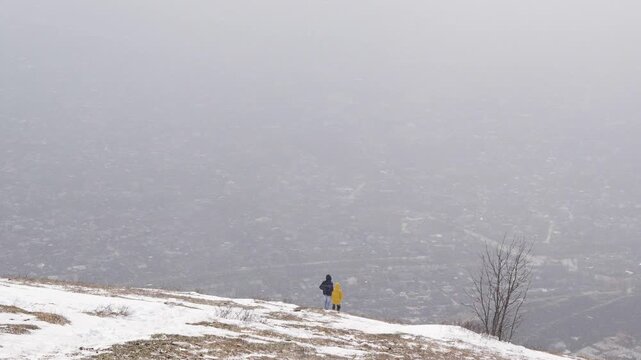 Two People Walking Through Blizzard in Snowy Field, Extreme Winter Storm Survival