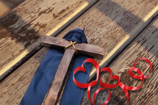 Red heart, Jesus cross on wooden desk