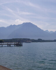 Fototapeta premium Lake geneva water with dock and alps mountains