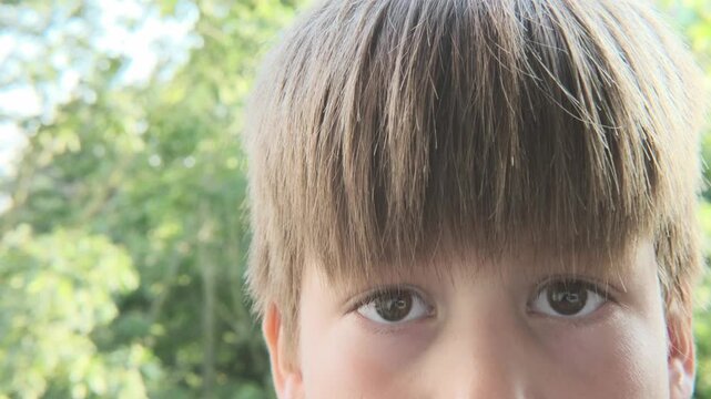 close-up part child's face, boy 10 years old Asian-European appearance, human eye looking seriously, fatigue, mental disease
