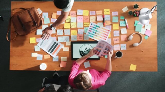 Time lapse of manager writing idea on sticky notes and explain idea about web design. Skilled marketing team or programmer brainstorming idea while looking at tablet with color palette. Symposium.