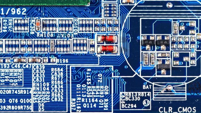 Extreme close-up macro shot of blue PCB with red diodes, SMD resistor arrays, buzzer pad and dense component markings under studio lighting