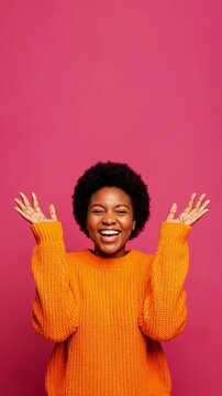 Excited black woman shouting in surprise raising hands on pink background bright emotion for advertising concept