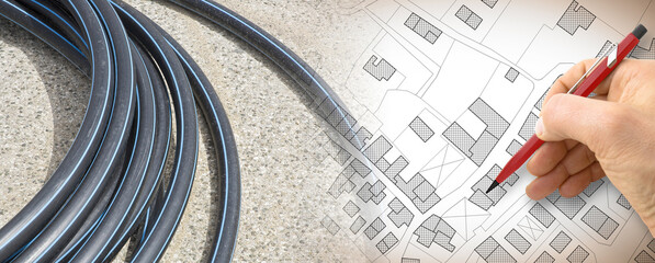 Black polyethylene pipes on a urban road of a construction site with new hydraulic system