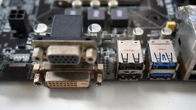 Close-up of computer motherboard ports including DVI, USB, and connectors.