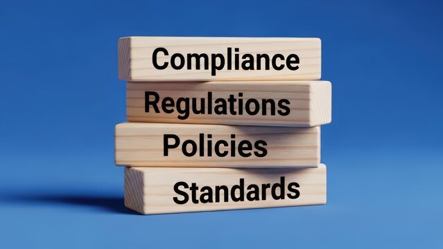 compliance concept  A stack of wooden blocks with compliance, regulations, policies, and standards written on them
