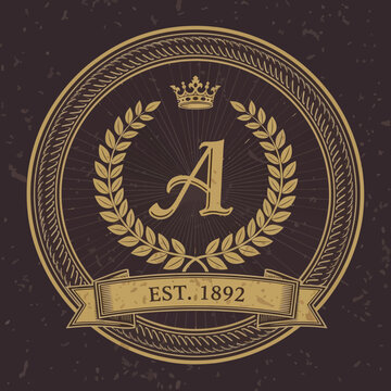Elegant antique gold badge logo design featuring a distinguished initial letter A, a regal crown, and a laurel wreath, ideal for luxurious vintage branding