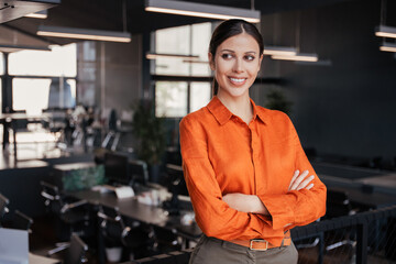Portrait of young indian middle eastern ceo woman smiling cheerfully looking dreaming aside. Latin...